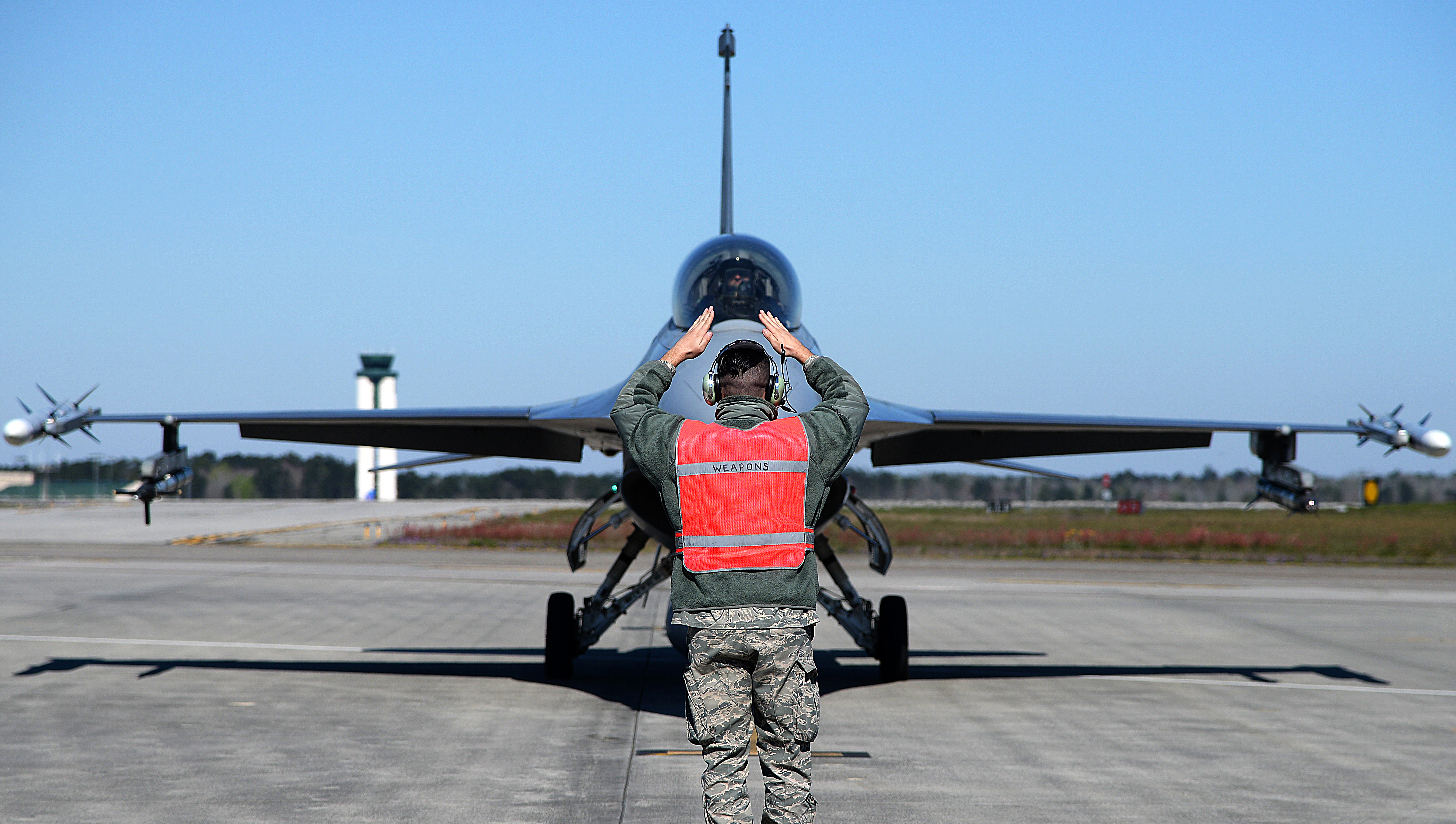 A photo of Tech. Sgt. Jeffrey J. Rain signaling an F-16 Fighting Falcon prior to launch.